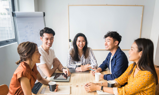 Office workers discussing about work happily with office snacks