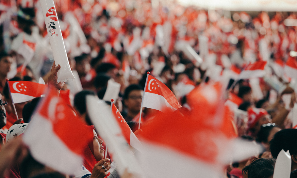 singaporeans waving their flags during ndp